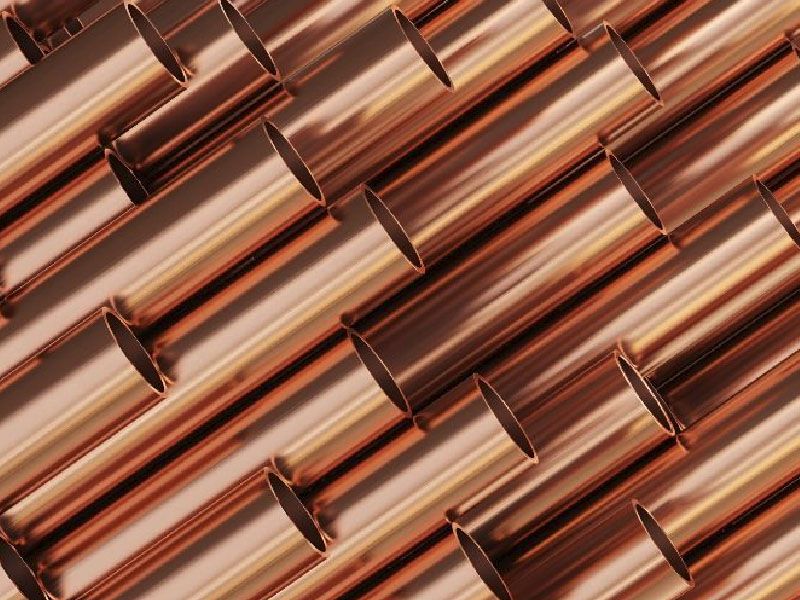 Plusieurs barres rondes de couleur bronze avec des faces lisses et cylindriques, disposées en diagonale.