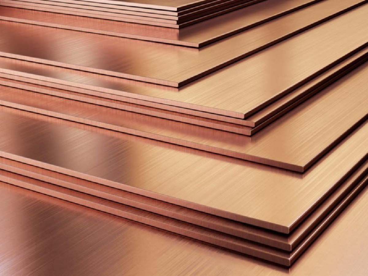 Stacked metallic sheets with a smooth surface and copper-colored tint.